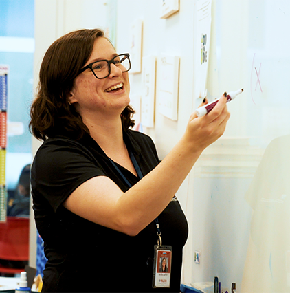 Valor Arizona teacher writing on a whitebooard