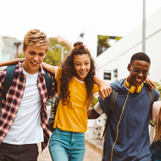 Students walking down a street together, laughing